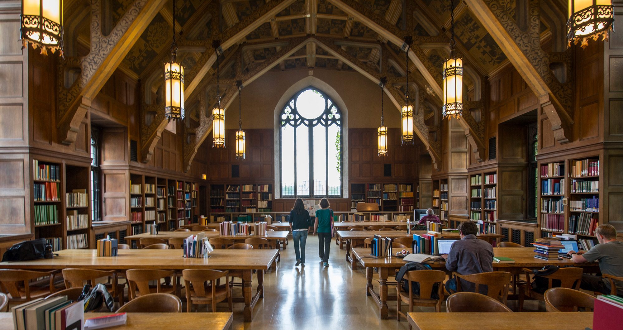 Wide view of a large hall in a gothic university library 