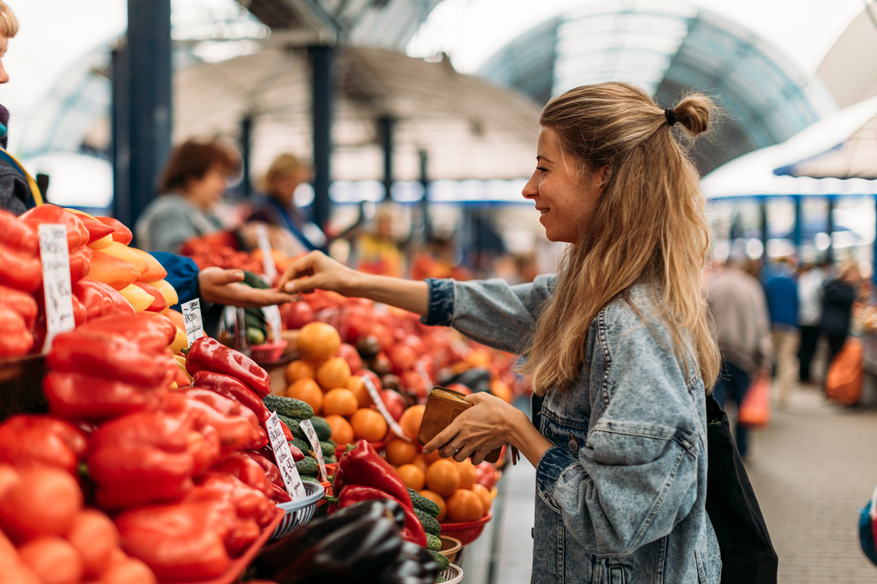 Woman buying fruits and vegetables on the market, Minks, Belarus.