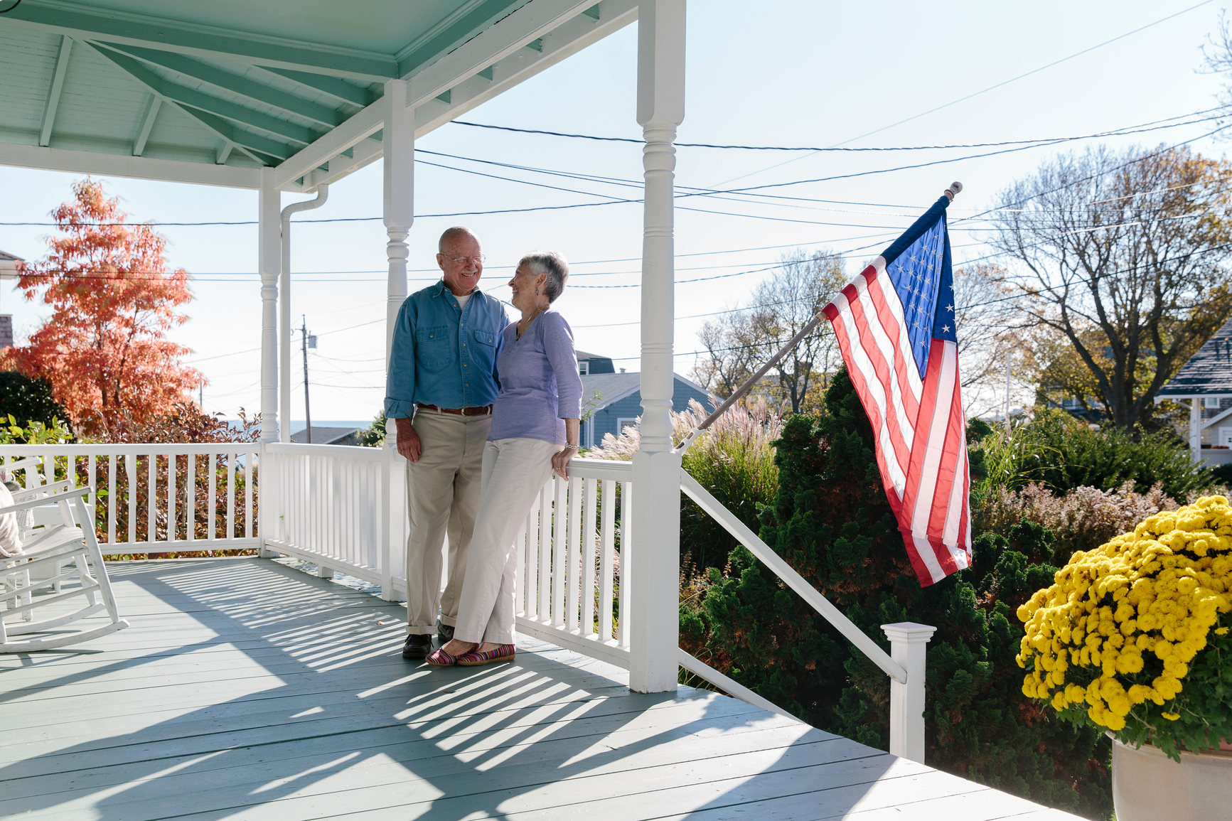 Stock Photo of Senior Couple Relaxing on Front Porch of Home 