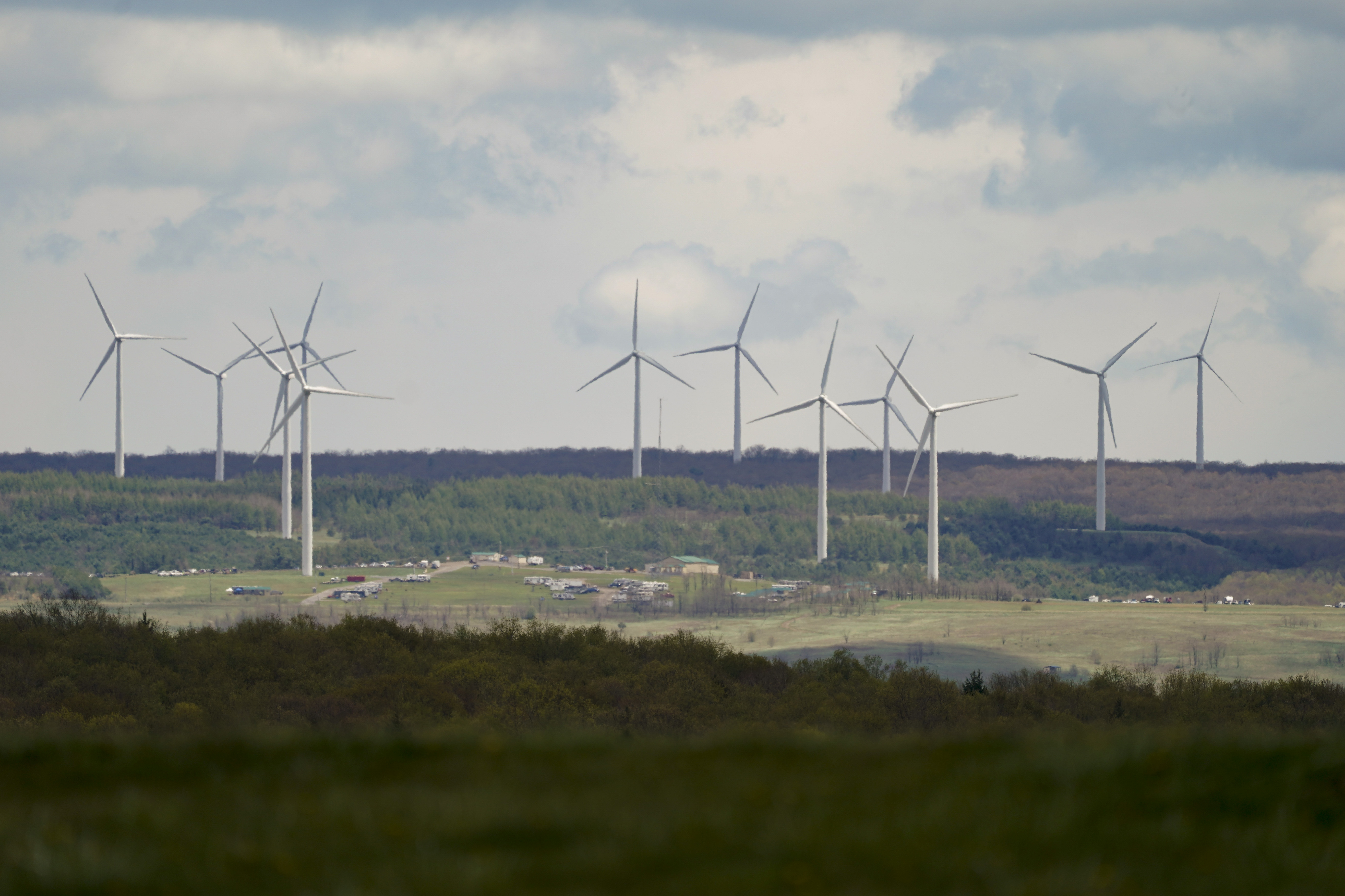 Wind turbine electric power generators are seen from the Flight 93 National Memorial, Saturday, May 8, 2021, in Shanksville, Pa. (AP Photo/Keith Srakocic)