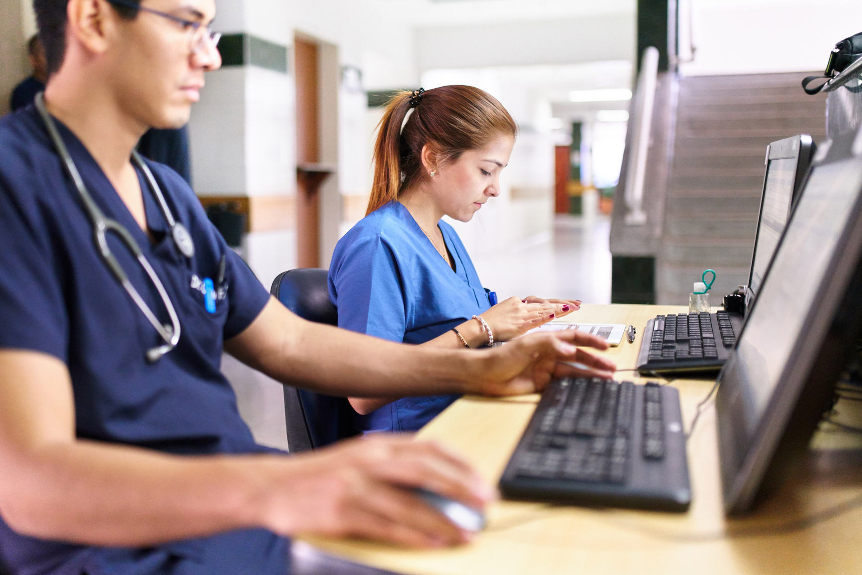 Health providers typing on laptops